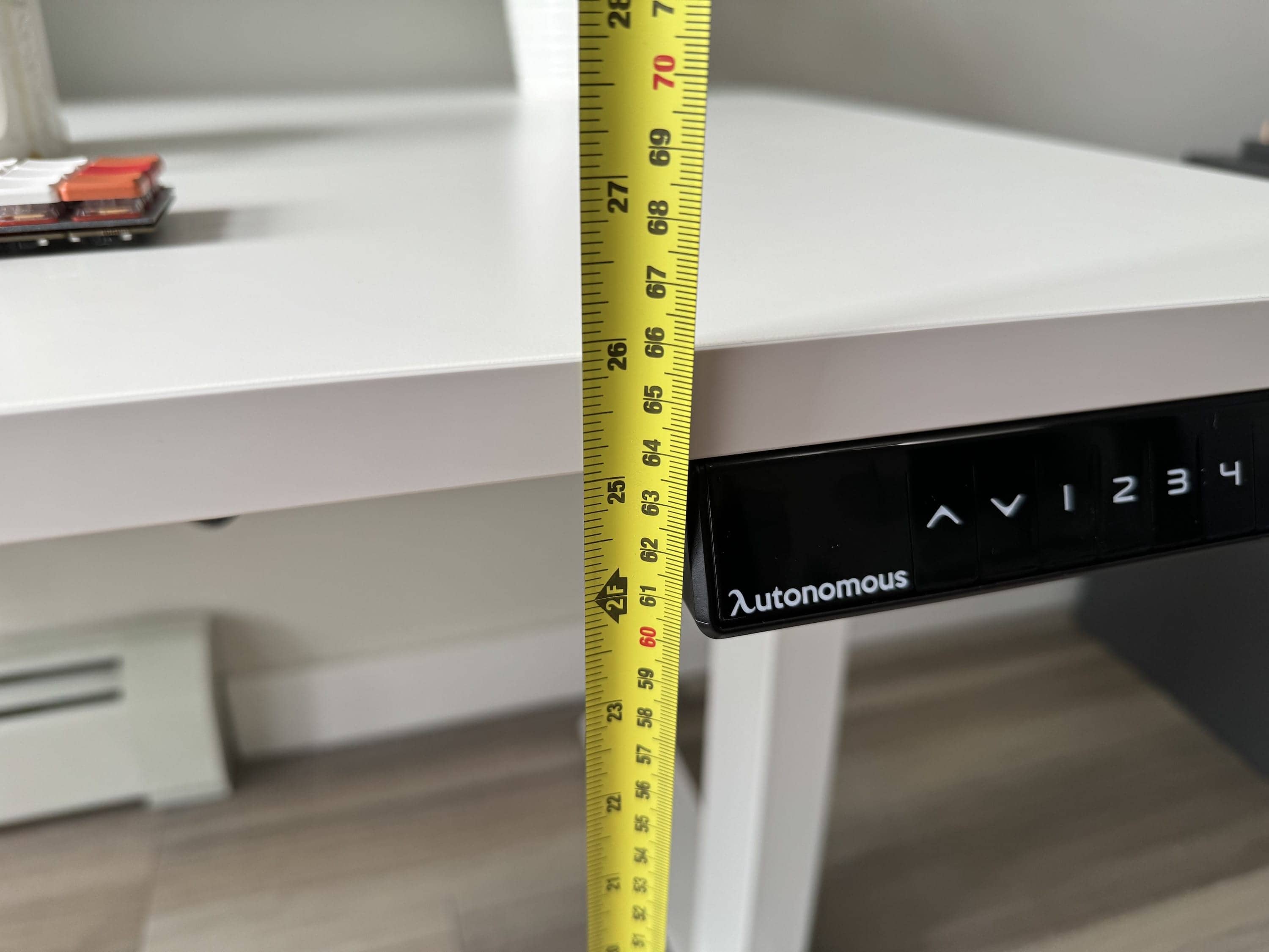 Measuring tape showing the Autonomous desk at 25 inches tall at its lowest position
