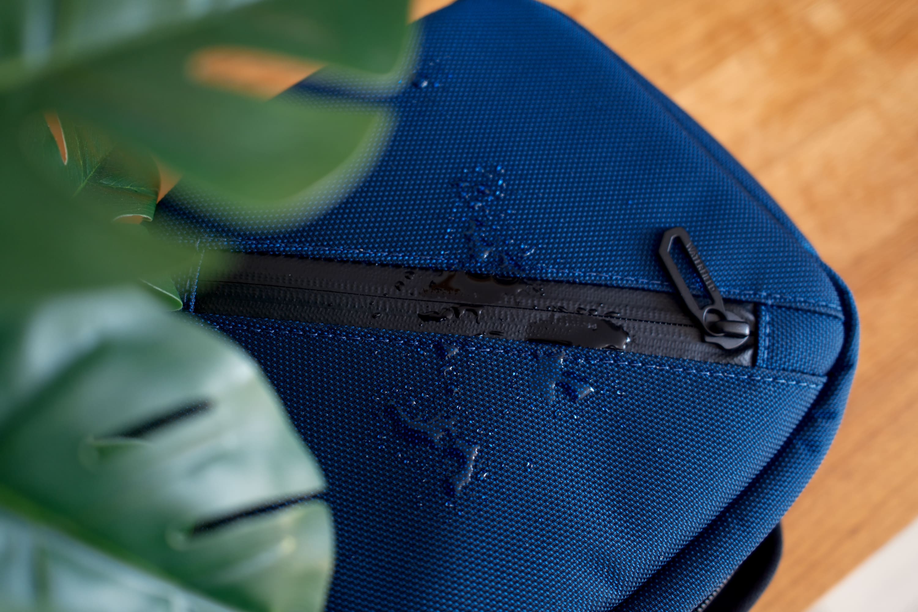 Water droplets beading on top of the case and zipper.