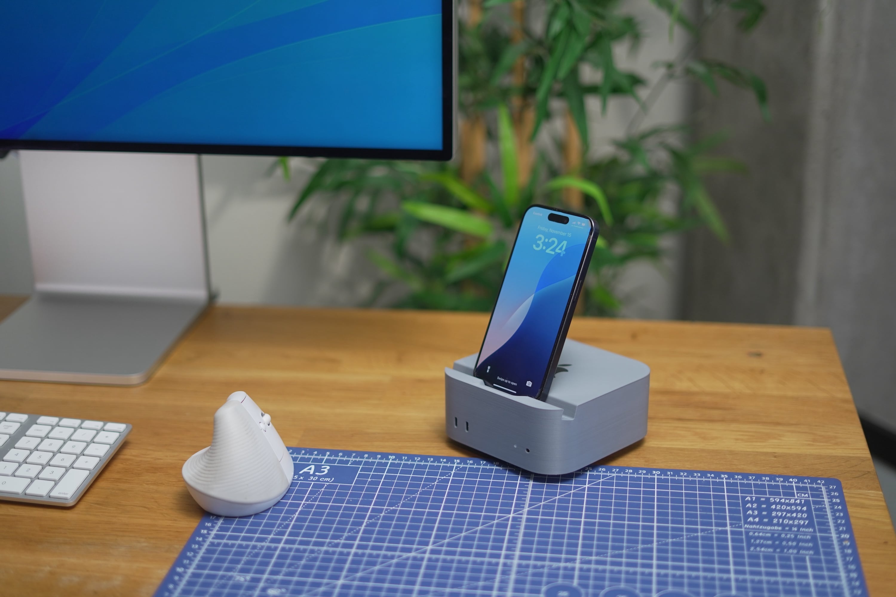 A 3D printed Mac mini with a groove in the top surface to hold a phone upright