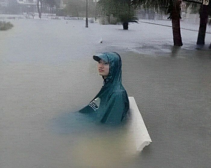 Person casually sitting on a bench in a flood