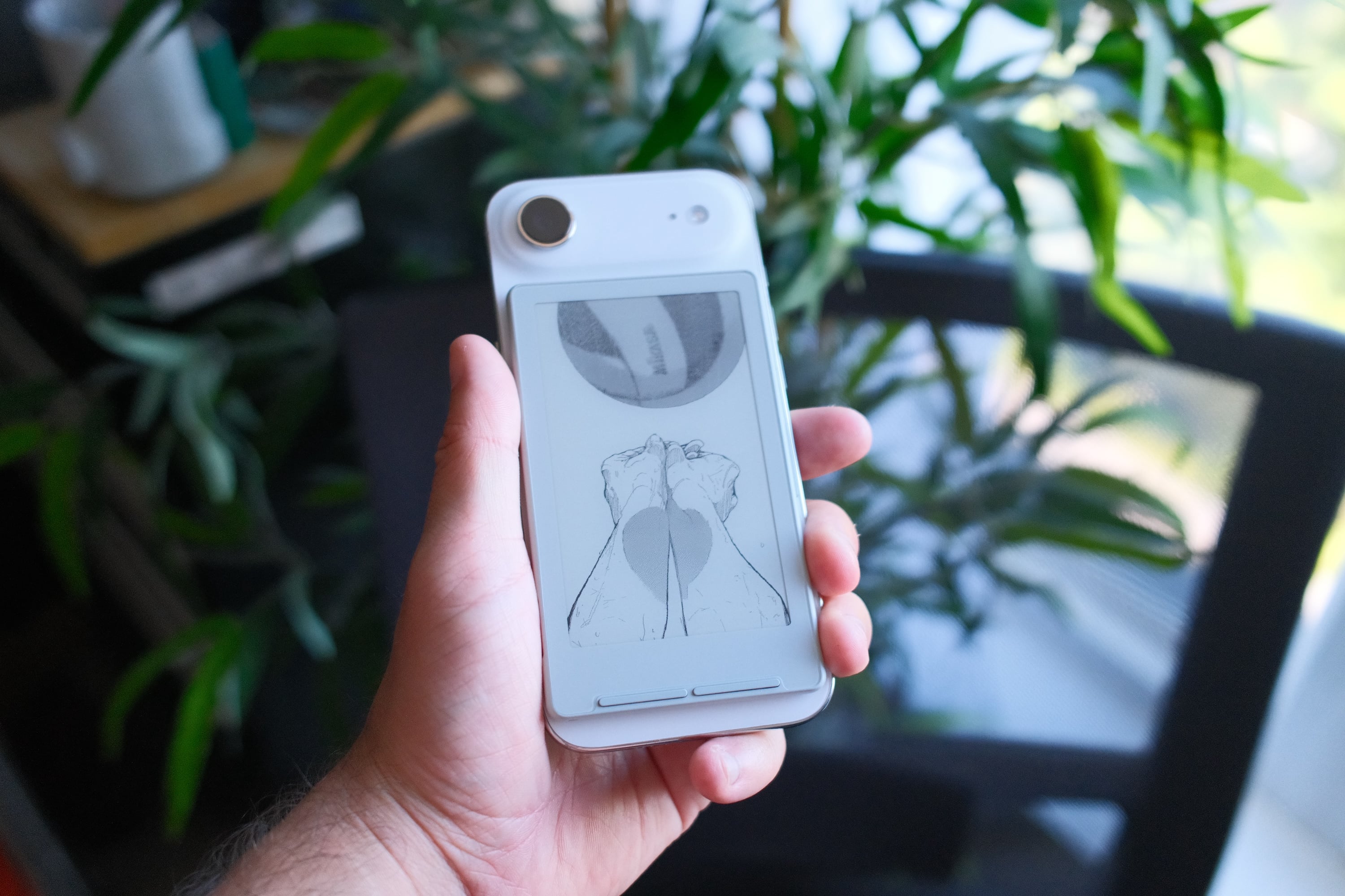 iPhone Air with an Xteink X4 attached to the back