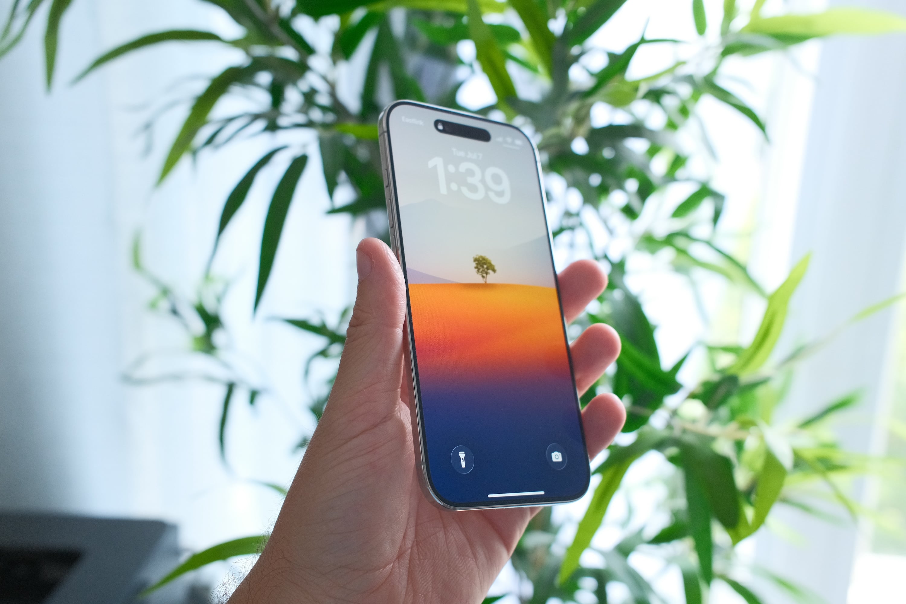 The iPhone Air held up in my hand against a leafy backdrop